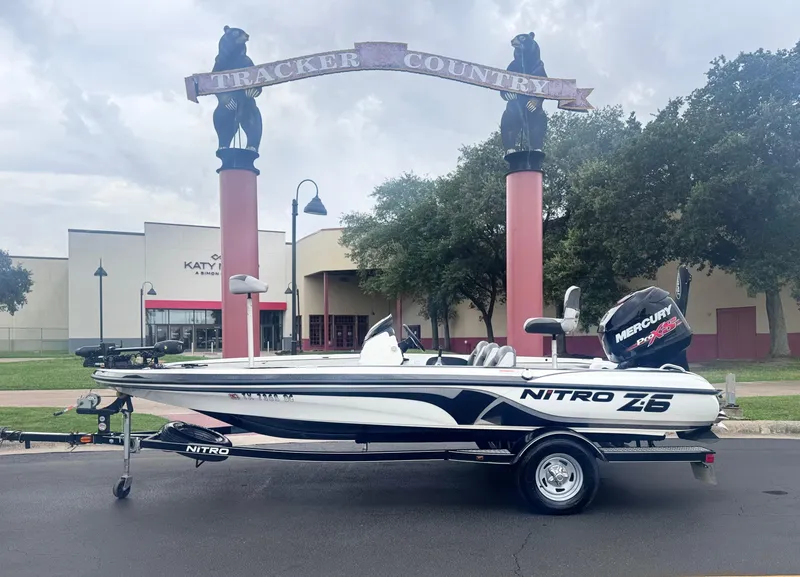 Slide: The Image of 2015 Nitro Z6 SC boat with Mercury engine, parked near Tracker Country sign. - 0