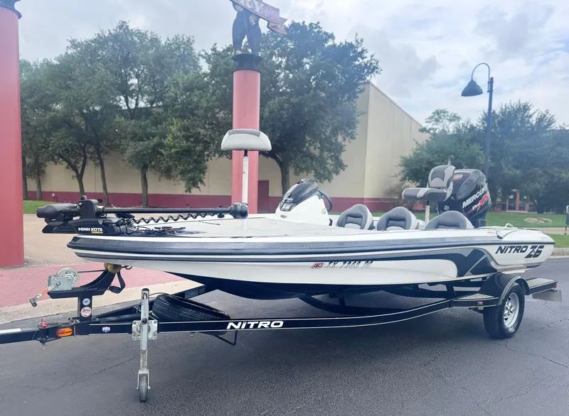 Slide: The Image of 2015 Nitro Z6 SC boat on trailer, parked outdoors with trees in background. - 1