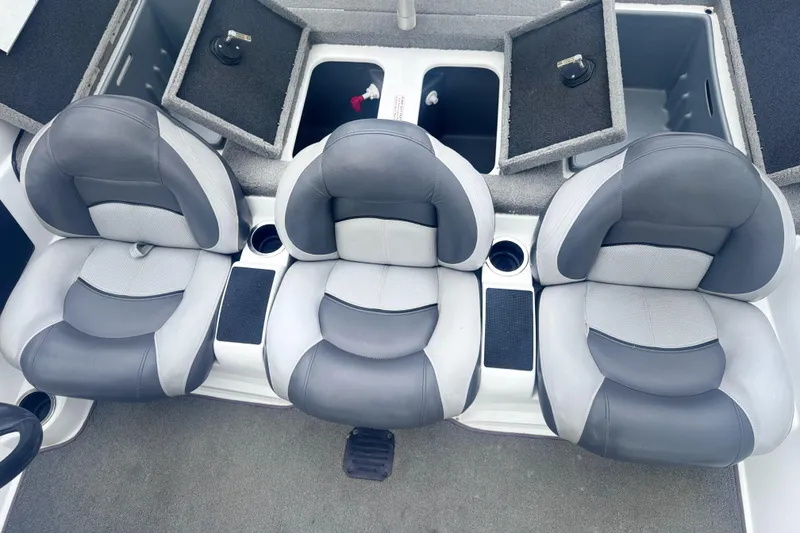 Slide: The Image of Three gray seats on a 2015 Nitro Z6 SC boat with storage compartments open. - 10