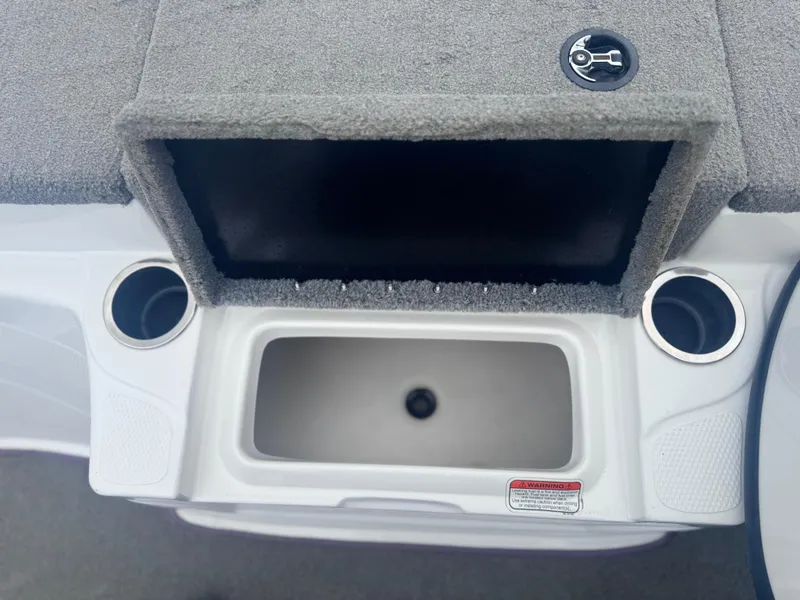Slide: The Image of 2015 Nitro Z6 SC boat storage compartment with cup holders and carpeted lid. - 8
