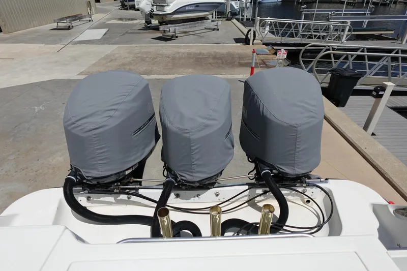 Slide: The Image of 2005 Hydra-Sports Vector 3300 CC with triple covered outboard engines at a marina. - 10