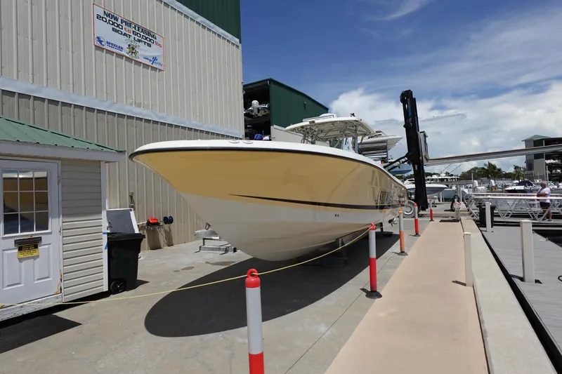 Slide: The Image of 2005 Hydra-Sports Vector 3300 CC boat docked at a marina under a clear sky. - 11