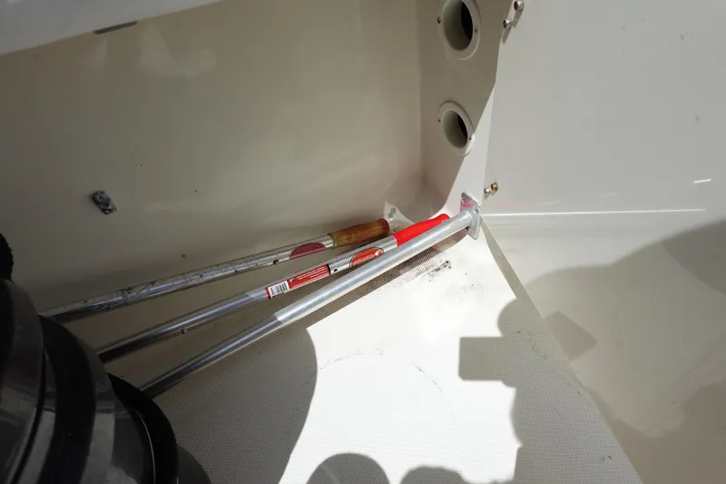 Slide: The Image of 2005 Hydra-Sports Vector 3300 CC interior with stored boat hooks and clean white surface. - 18