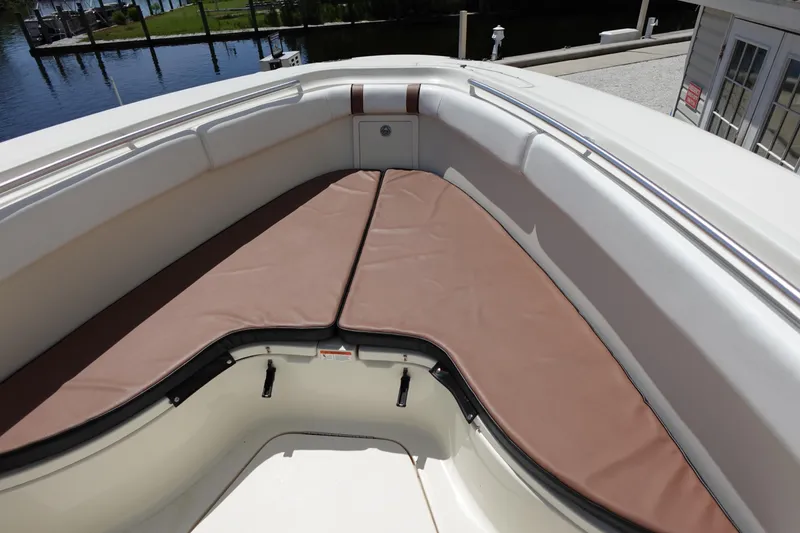 Slide: The Image of 2005 Hydra-Sports Vector 3300 CC boat with cushioned seating area, docked by the water. - 43