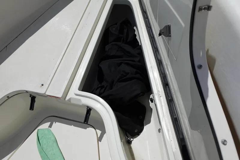 Slide: The Image of Storage compartment on a 2005 Hydra-Sports Vector 3300 CC boat, containing black fabric. - 45
