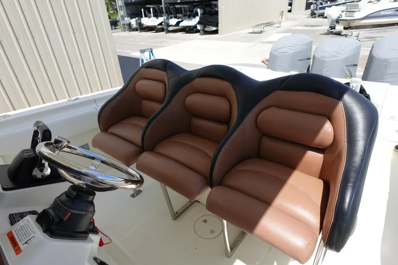 Slide: The Image of 2005 Hydra-Sports Vector 3300 CC boat with three brown and black cushioned seats. - 5