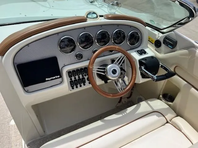 Slide: The Image of 2008 Chris-Craft Launch 28 dashboard with brown leather trim and storage compartment. - 10