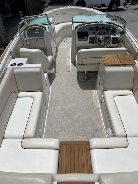 Slide: The Image of 2008 Chris-Craft Launch 28 boat interior with beige seating and wooden accents. - 7