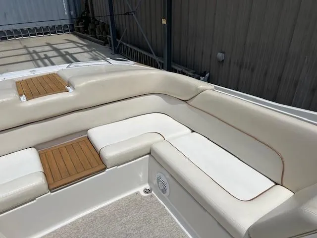 Slide: The Image of 2008 Chris-Craft Launch 28 boat interior with beige seating and wooden accents. - 8