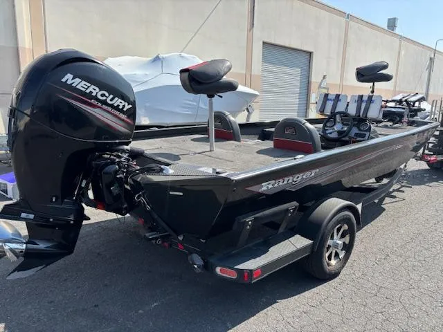 Slide: The Image of 2017 Ranger RT198P boat with Mercury engine, parked outdoors on a trailer. - 2