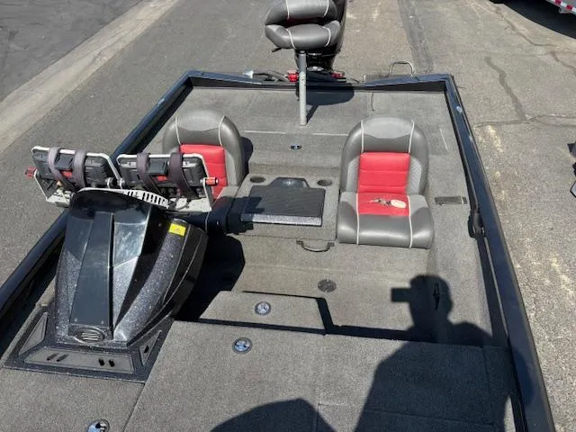 Slide: The Image of 2017 Ranger RT198P boat interior with gray and red seats, fishing rod holders, and carpeted deck. - 7