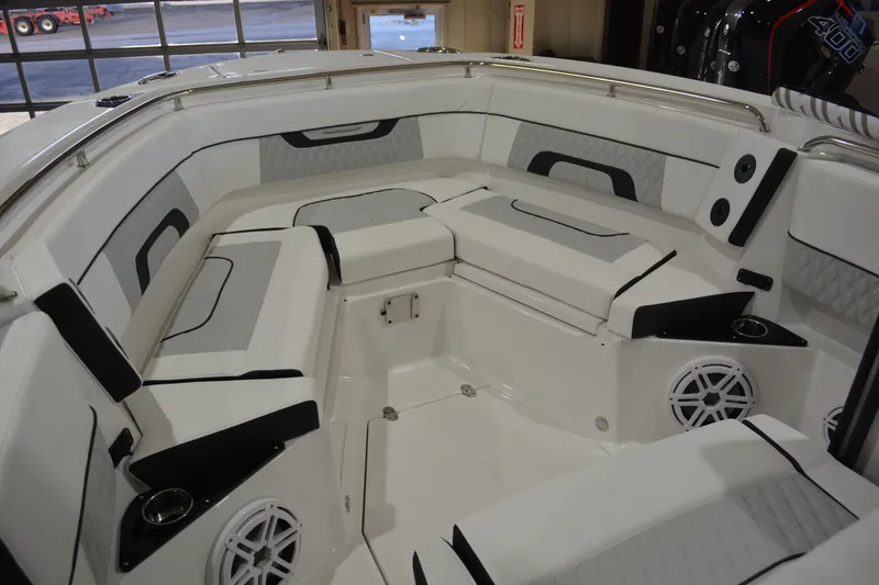Slide: The Image of 2026 Blackfin 272 CC boat interior with cushioned seating and built-in speakers. - 21