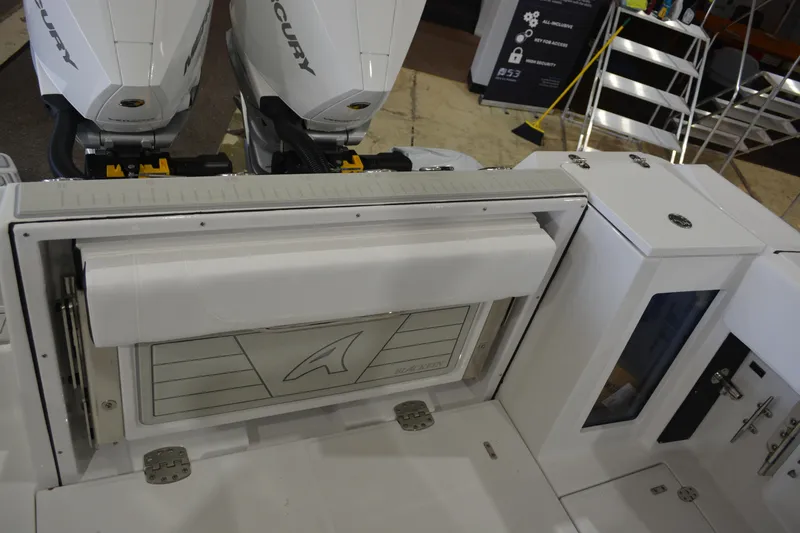 Slide: The Image of 2026 Blackfin 272 CC boat interior with dual Mercury engines and storage compartments. - 25