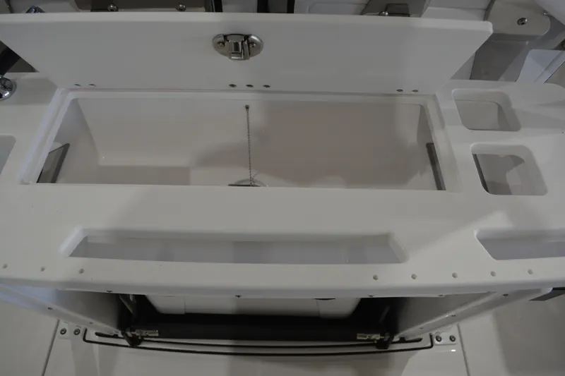 Slide: The Image of 2026 Blackfin 272 CC boat storage compartment with open lid, showcasing interior space. - 29