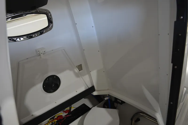 Slide: The Image of Interior cabin of 2026 Blackfin 272 CC boat, featuring sleek white design and porthole window. - 33