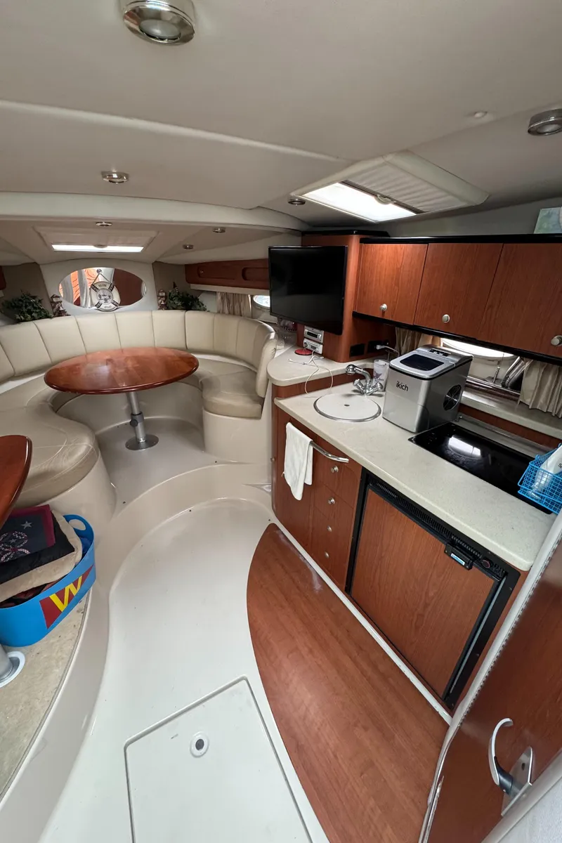 Slide: The Image of 2004 Chaparral 330 Signature yacht interior with kitchen, dining area, and modern amenities. - 14