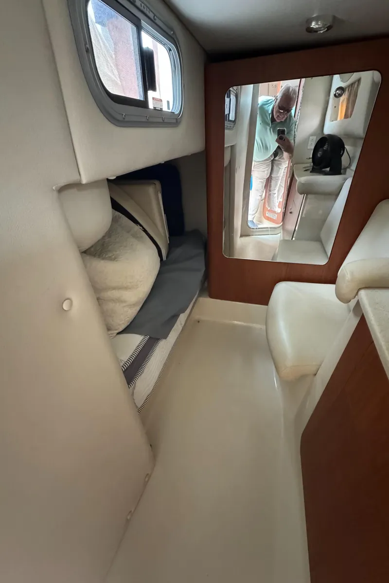Slide: The Image of 2004 Chaparral 330 Signature cabin interior with bed, window, and mirror. - 15