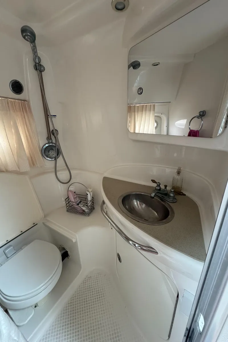 Slide: The Image of 2004 Chaparral 330 Signature boat bathroom with shower, sink, and toilet. - 18