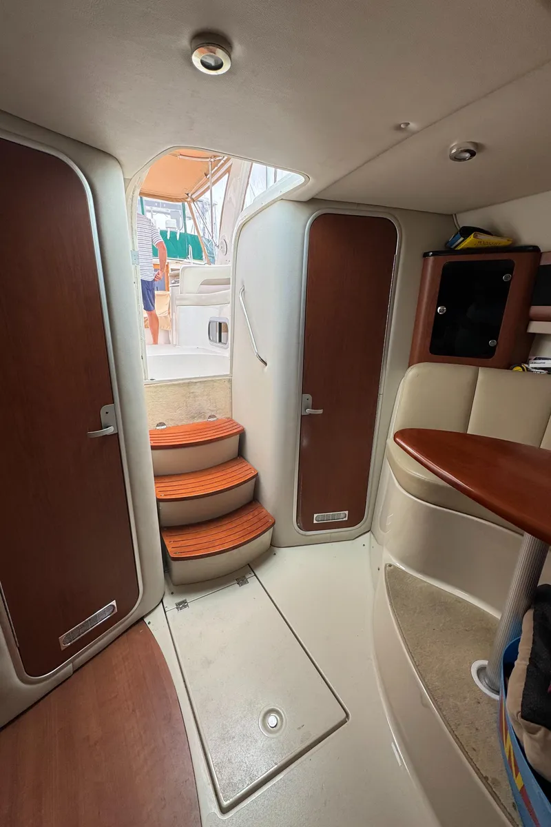 Slide: The Image of Interior of 2004 Chaparral 330 Signature boat with wooden doors and steps. - 23