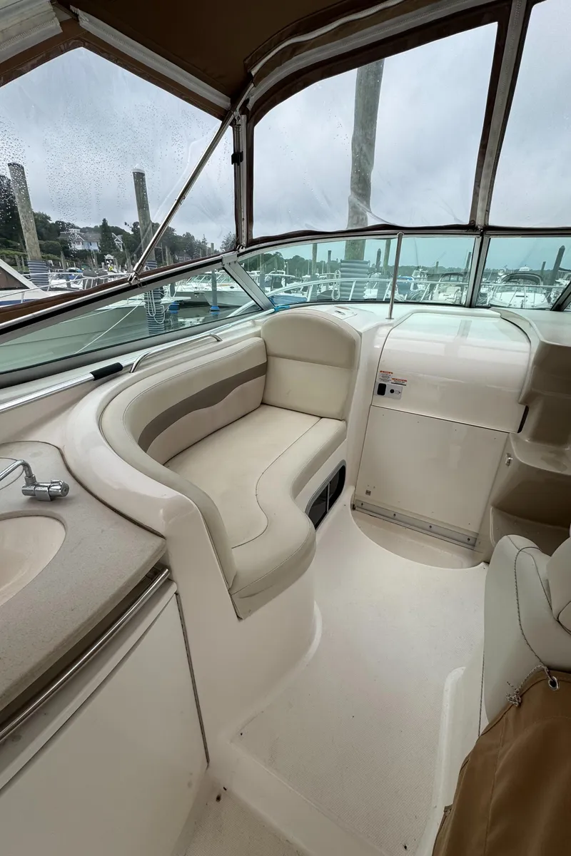 Slide: The Image of 2004 Chaparral 330 Signature boat interior with seating and helm, docked at marina. - 3