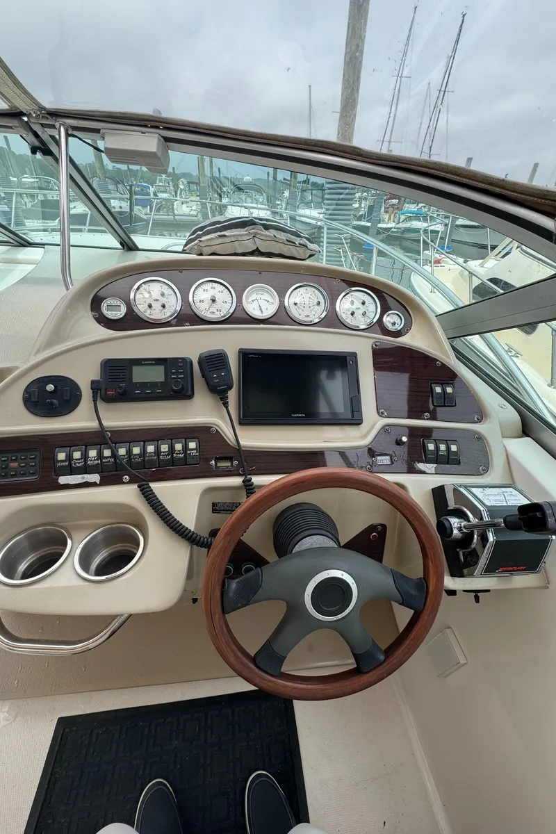 Slide: The Image of 2004 Chaparral 330 Signature boat dashboard with gauges, controls, and steering wheel. - 4
