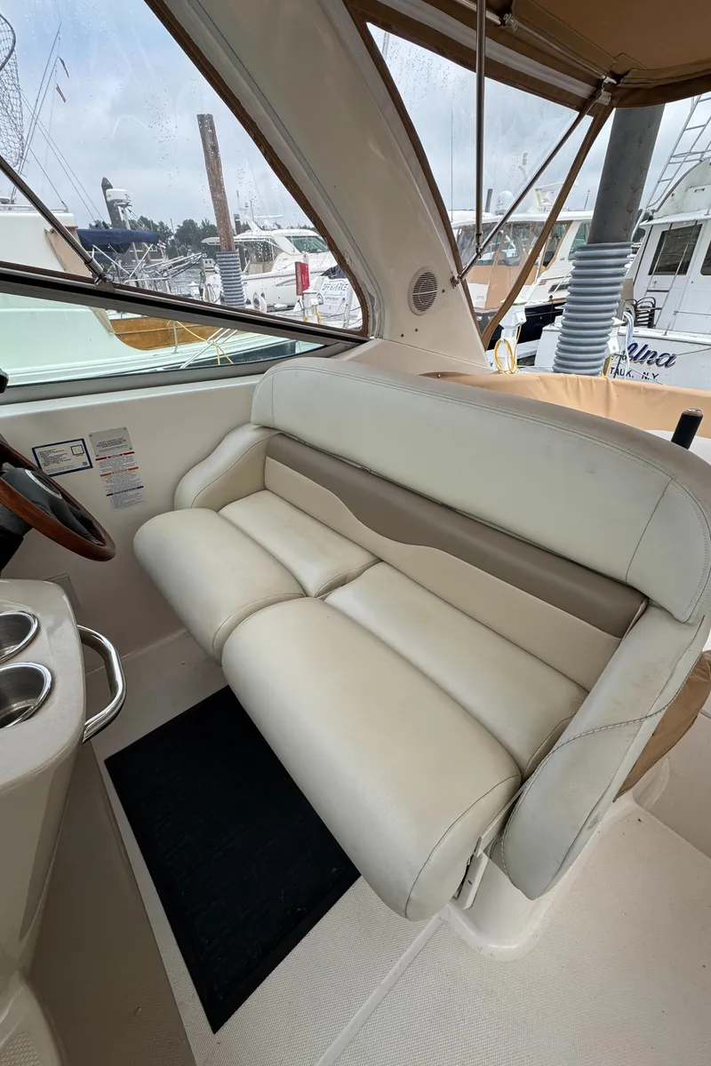 Slide: The Image of 2004 Chaparral 330 Signature boat interior with white leather seating and steering wheel. - 8