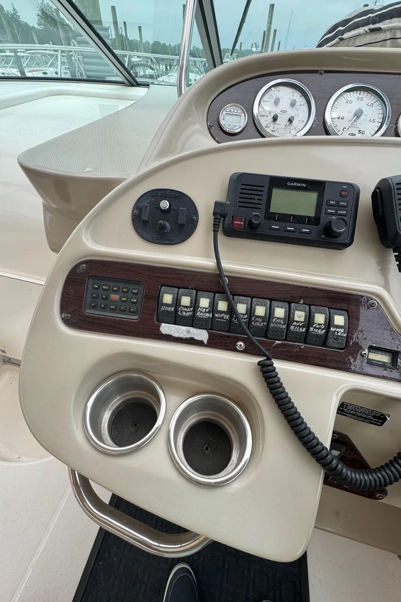 Slide: The Image of Control panel of a 2004 Chaparral 330 Signature boat with gauges and radio. - 9
