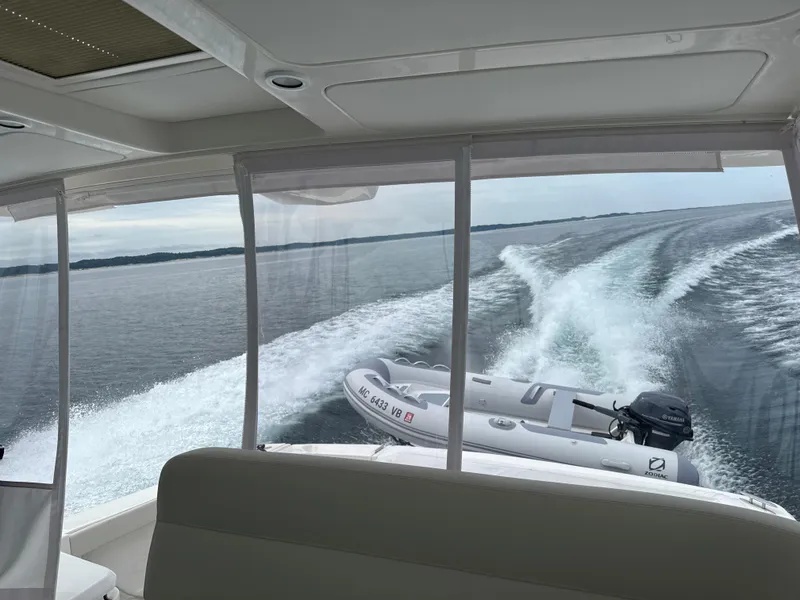 Slide: The Image of 2022 Tiara Yachts 39 Open cruising with inflatable boat in tow. - 15