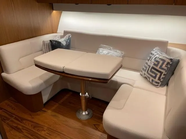 Slide: The Image of 2022 Tiara Yachts 39 Open interior with elegant seating and wooden flooring. - 16