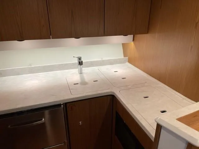 Slide: The Image of Modern kitchen area in 2022 Tiara Yachts 39 Open, featuring sleek countertops and cabinetry. - 17