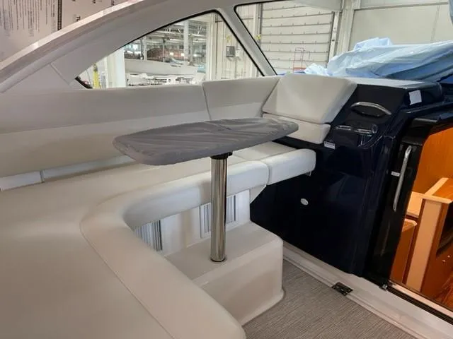 Slide: The Image of 2022 Tiara Yachts 39 Open interior with sleek seating and modern table design. - 18