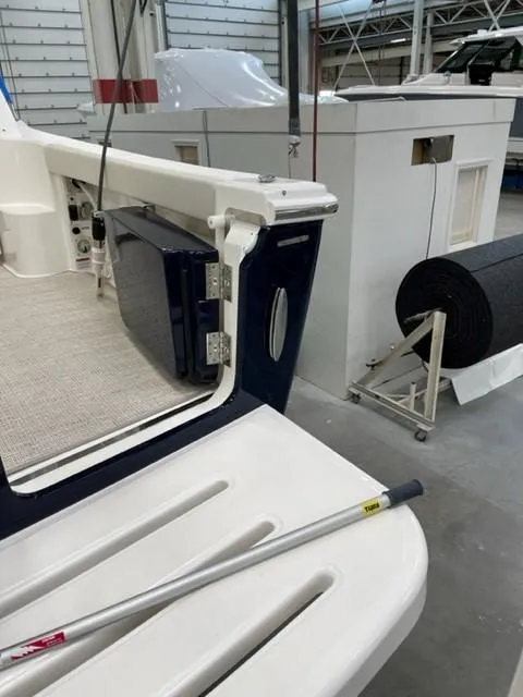 Slide: The Image of 2022 Tiara Yachts 39 Open in a workshop, showcasing deck and interior details. - 21