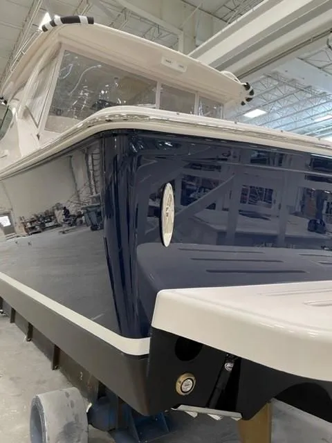 Slide: The Image of 2022 Tiara Yachts 39 Open in a showroom, showcasing sleek design and craftsmanship. - 22