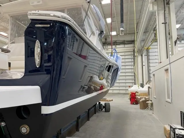 Slide: The Image of 2022 Tiara Yachts 39 Open in a workshop, showcasing sleek design and craftsmanship. - 23