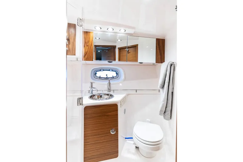 Slide: The Image of Manufacturer Provided Image: Modern bathroom in 2022 Tiara Yachts 39 Open, featuring wood accents and sleek fixtures. - 24