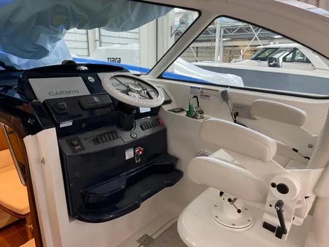 Slide: The Image of 2022 Tiara Yachts 39 Open helm with Garmin navigation and white seating. - 5