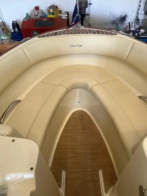 Slide: The Image of 2020 Chris-Craft Launch 27 boat interior with beige seating and wooden flooring. - 11