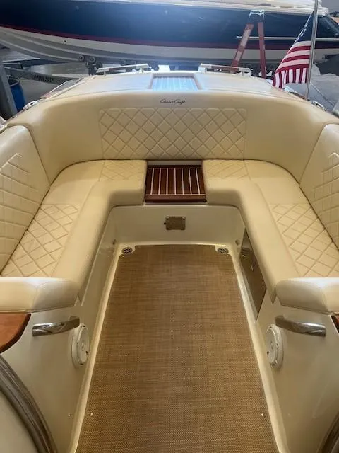 Slide: The Image of 2020 Chris-Craft Launch 27 interior with beige seating and wooden accents. - 14