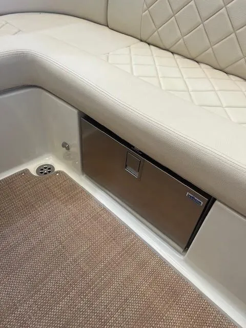 Slide: The Image of 2020 Chris-Craft Launch 27 interior with quilted seating and built-in storage compartment. - 15