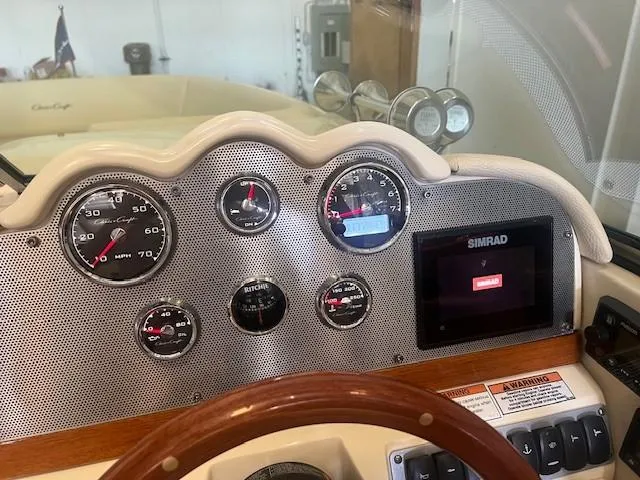 Slide: The Image of Dashboard of a 2020 Chris-Craft Launch 27 boat with gauges and Simrad display. - 16