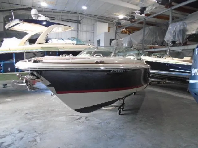 Slide: The Image of 2020 Chris-Craft Launch 27 boat in a storage facility, showcasing sleek design and craftsmanship. - 2