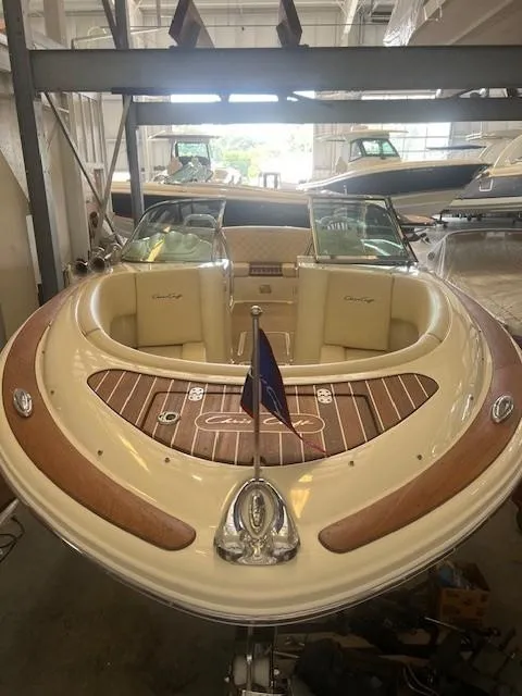 Slide: The Image of 2020 Chris-Craft Launch 27 boat with elegant wood accents in a showroom. - 7