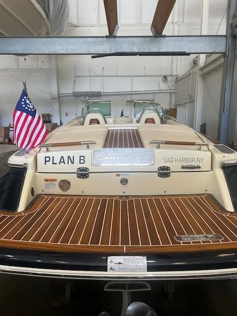 Slide: The Image of 2020 Chris-Craft Launch 27 boat with wooden deck, American flag, and "Plan B" nameplate. - 8