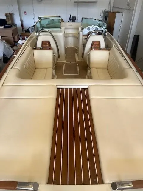 Slide: The Image of 2020 Chris-Craft Launch 27 boat interior with beige seating and wooden accents. - 9