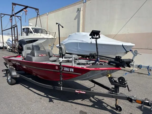 Slide: The Image of 2024 Tracker Bass Tracker Classic XL boat on trailer, parked outdoors. - 2