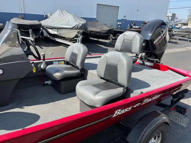 Slide: The Image of 2024 Tracker Bass Tracker Classic XL boat with dual seats and Mercury outboard motor. - 4