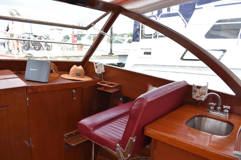 Slide: The Image of Interior of a 1960 Chris-Craft Sea Skiff with red seating and wooden cabinetry. - 4