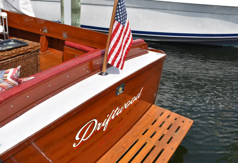 Slide: The Image of 1960 Chris-Craft Sea Skiff boat with American flag, docked on water. - 8