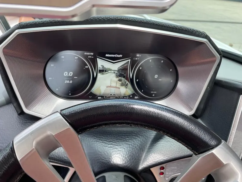 Slide: The Image of Dashboard of a 2019 MasterCraft XT23 boat with digital display and steering wheel. - 10