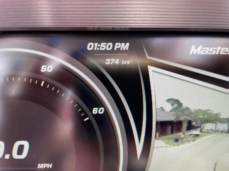 Slide: The Image of Dashboard of 2019 MasterCraft XT23 showing 374 hours and speedometer. - 11
